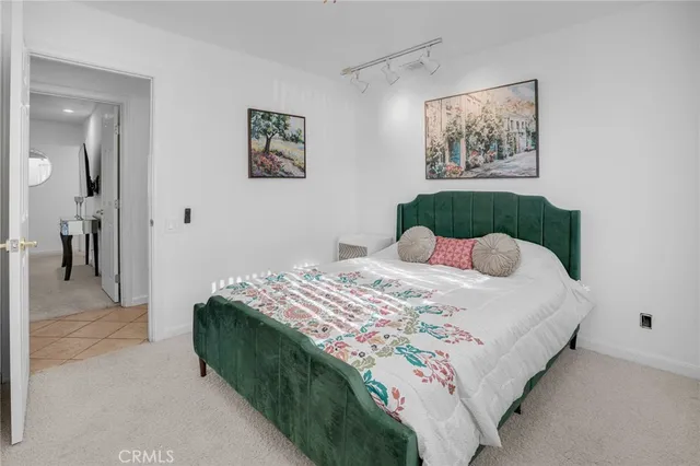 a bedroom with a bed and a painting on the wall