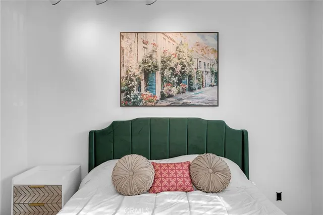 a bedroom with a bed and a chair