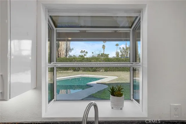 a view of kitchen island with stainless steel appliances granite countertop sink and wooden floor