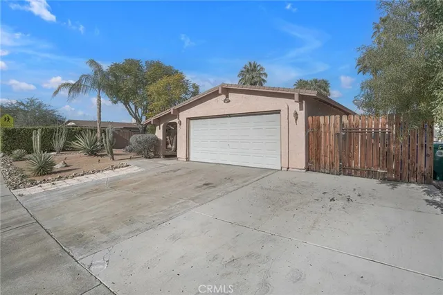 a front view of a house with a yard covered with snow