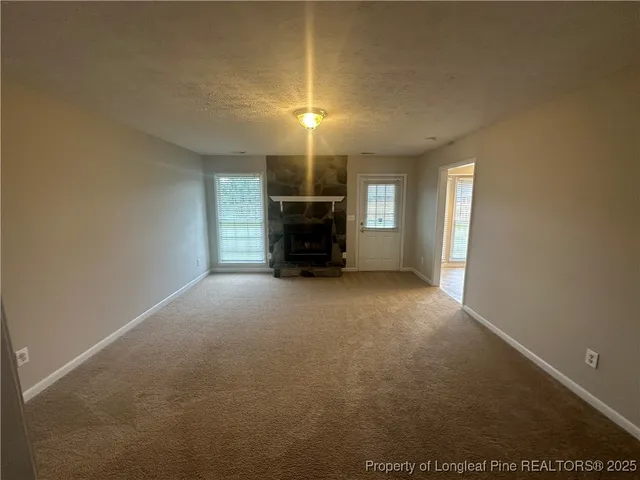 an empty room with windows and entrance