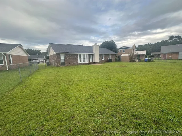 a front view of a house with a garden and yard