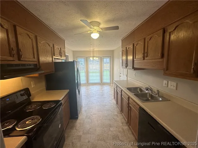 a kitchen with a stove and a refrigerator