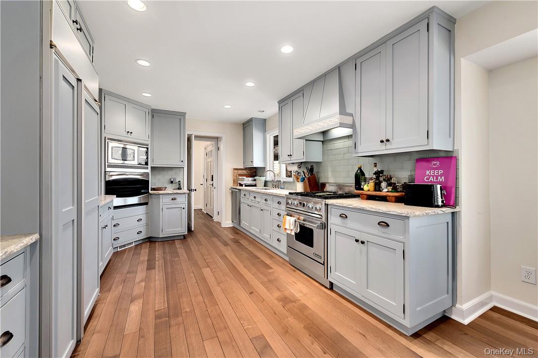 106 Old Stone Hill Road Pound Ridge, NY 10576 - Photo 17 of 25 a kitchen with white cabinets and appliances