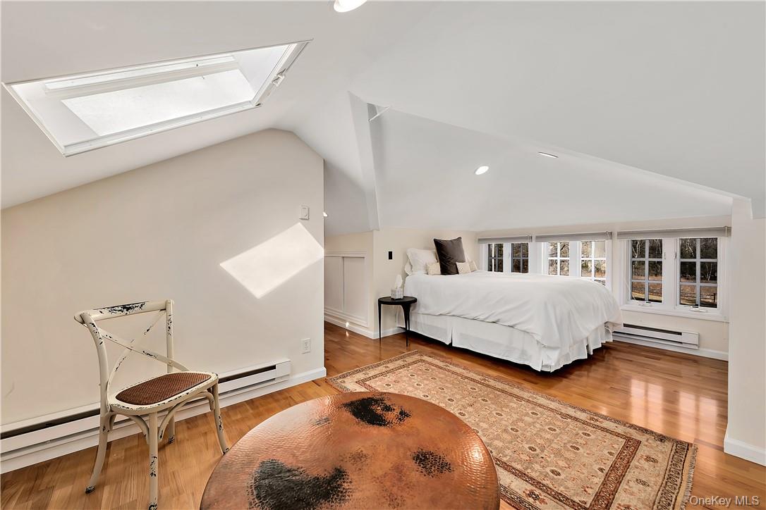 106 Old Stone Hill Road Pound Ridge, NY 10576 - Photo 18 of 25 a bedroom with a bed and a dresser with wooden floor