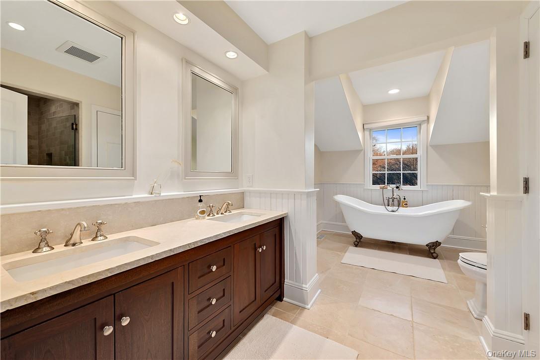 106 Old Stone Hill Road Pound Ridge, NY 10576 - Photo 19 of 25 a bathroom with a tub double sink and mirror