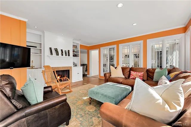a living room with furniture fireplace and a flat screen tv