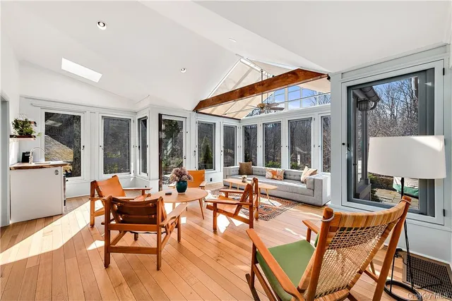 a living room with patio furniture and a large window