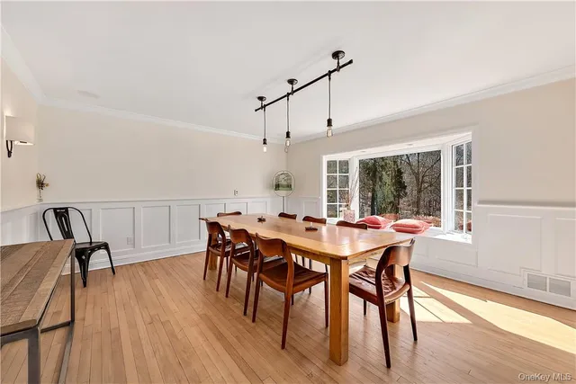 a view of a dining room with furniture window and wooden floor