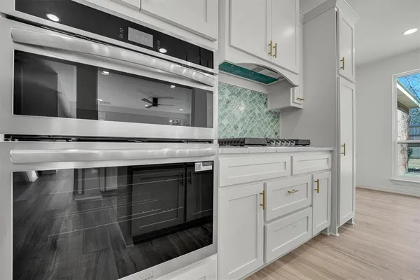 a kitchen with stainless steel appliances granite countertop a stove and a microwave