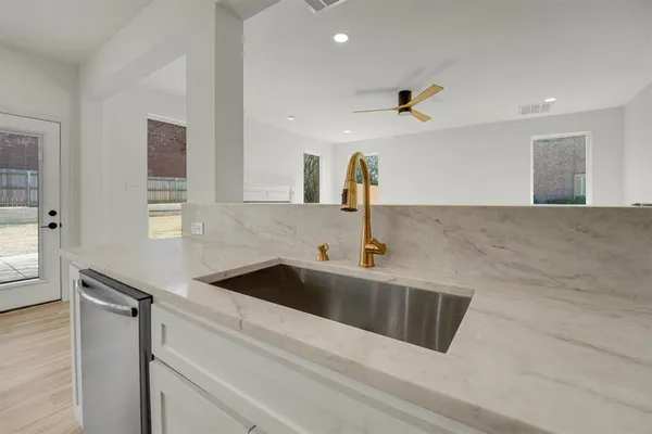 a kitchen with a sink and a refrigerator