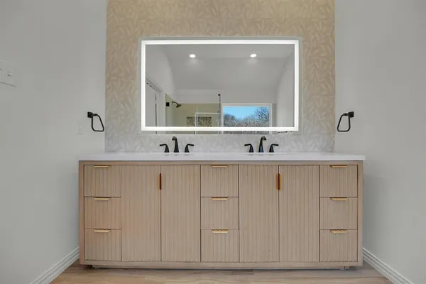 a bathroom with a sink vanity and mirror