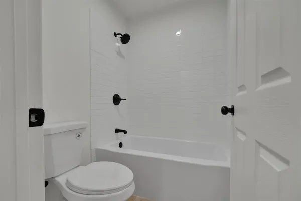 a bathroom with a bathtub a toilet and a shower