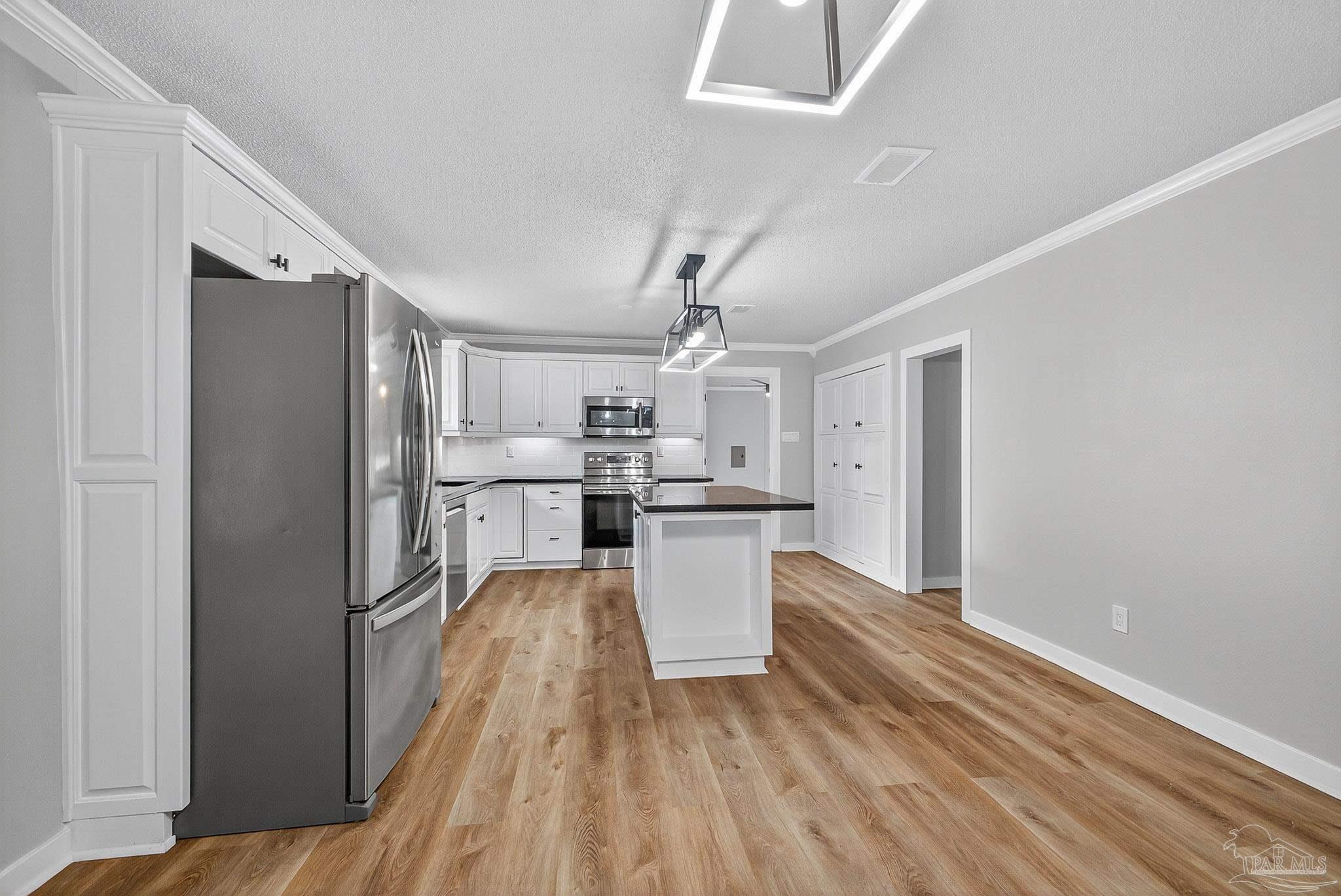 4673 Van Horn Road Milton, FL 32583 - Photo 17 of 53 a kitchen with stainless steel appliances granite countertop a refrigerator and a stove top oven