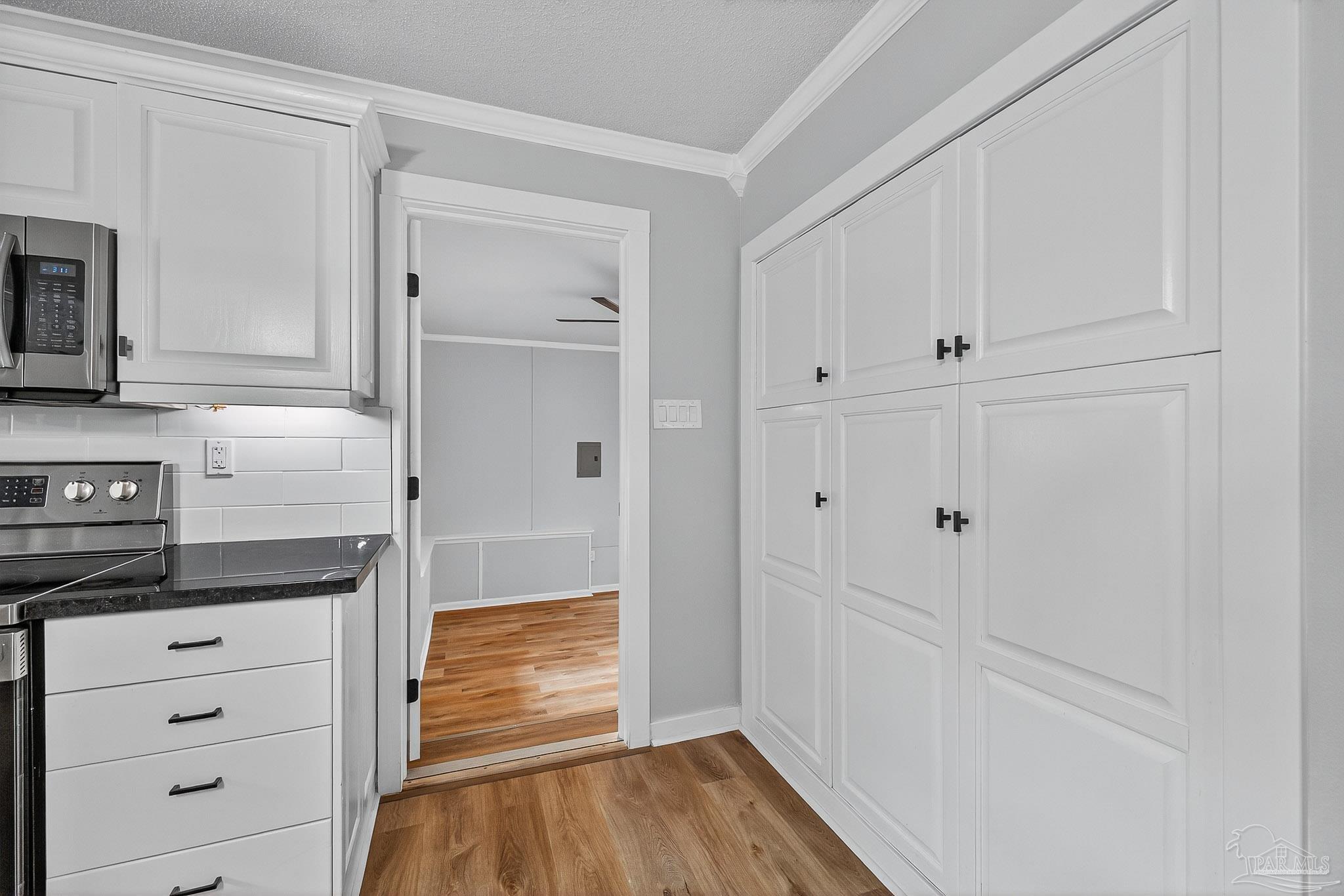 4673 Van Horn Road Milton, FL 32583 - Photo 24 of 53 a view of a kitchen with wooden floor