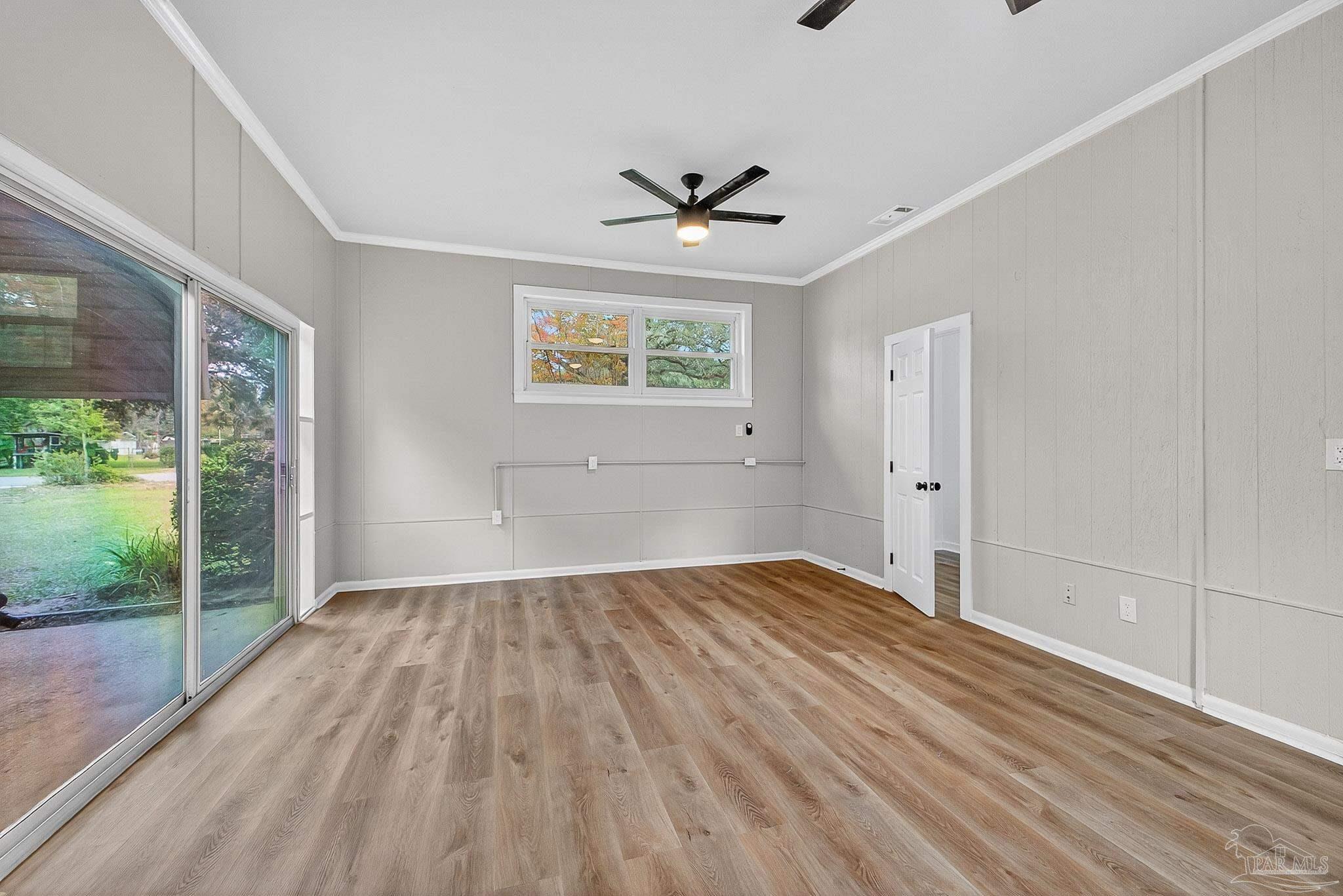 4673 Van Horn Road Milton, FL 32583 - Photo 25 of 53 a view of empty room with wooden floor and fan