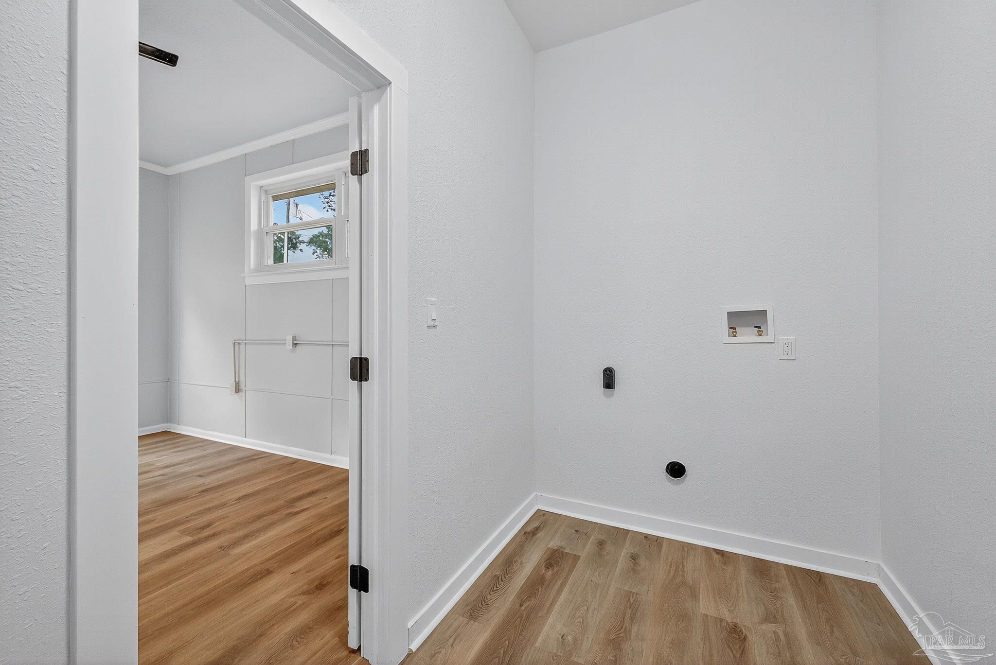 4673 Van Horn Road Milton, FL 32583 - Photo 28 of 53 a view of a hallway with wooden floor