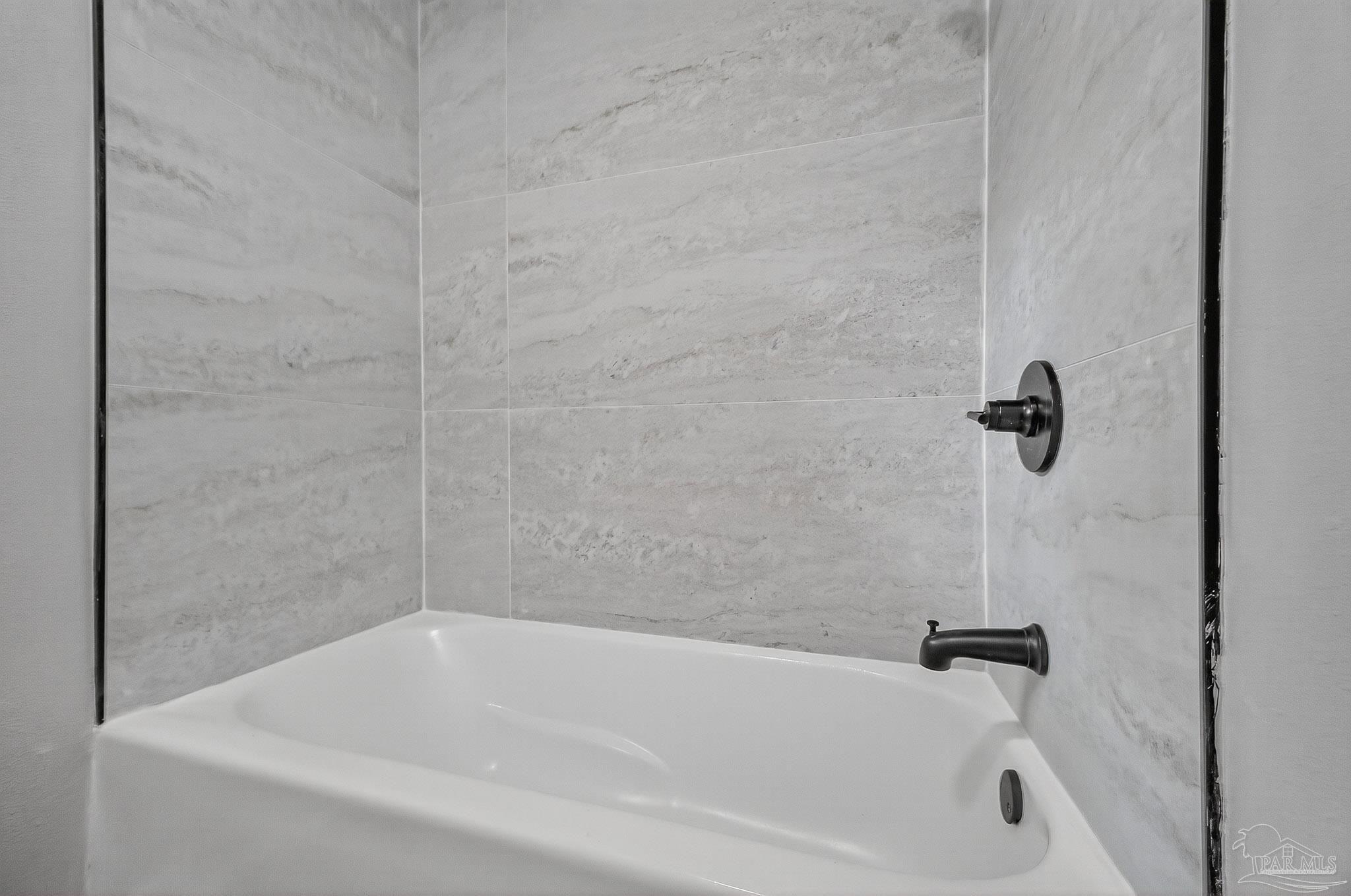 4673 Van Horn Road Milton, FL 32583 - Photo 35 of 53 a white bath tub sitting next to a shower