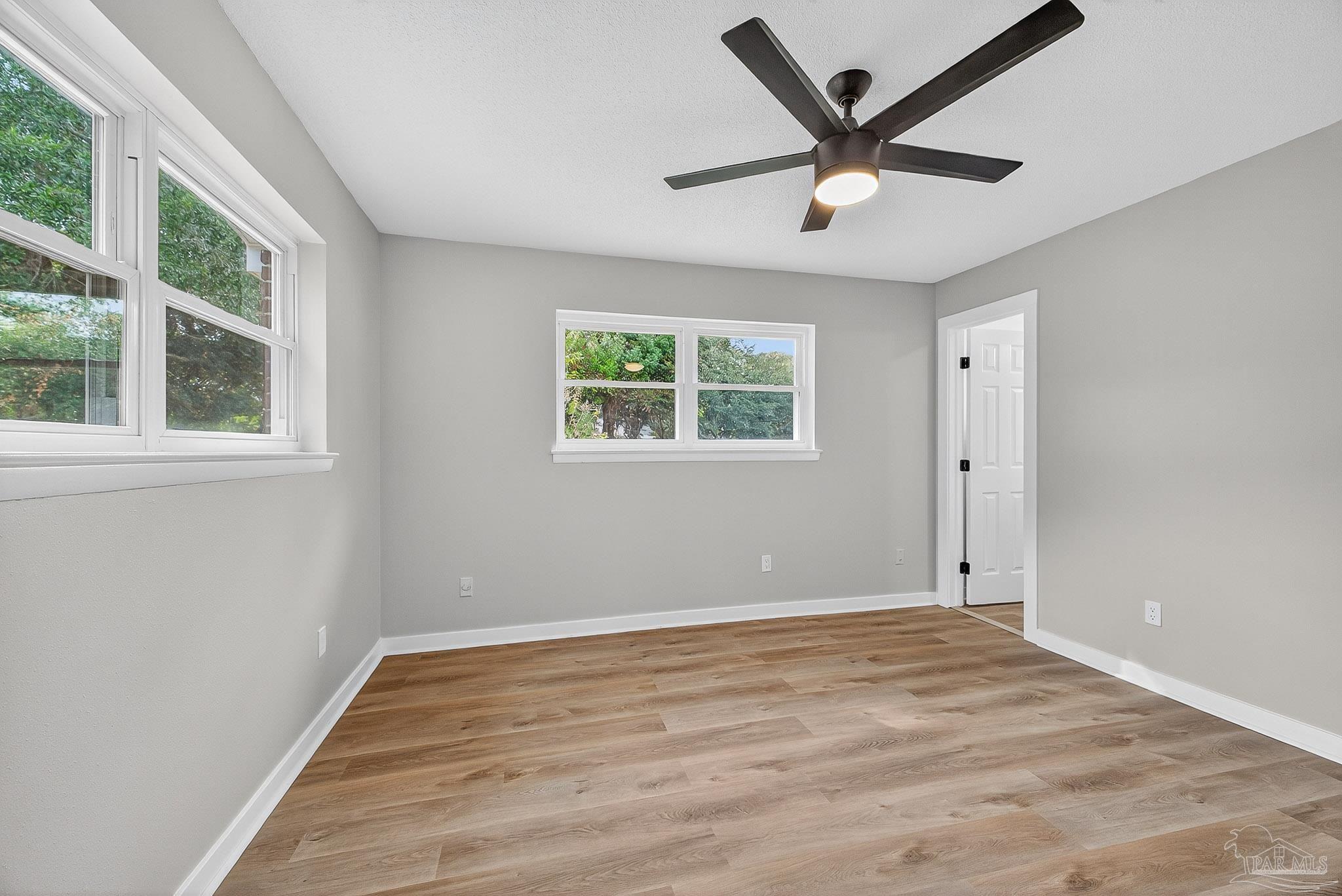 4673 Van Horn Road Milton, FL 32583 - Photo 42 of 53 wooden floor in an empty room with a window