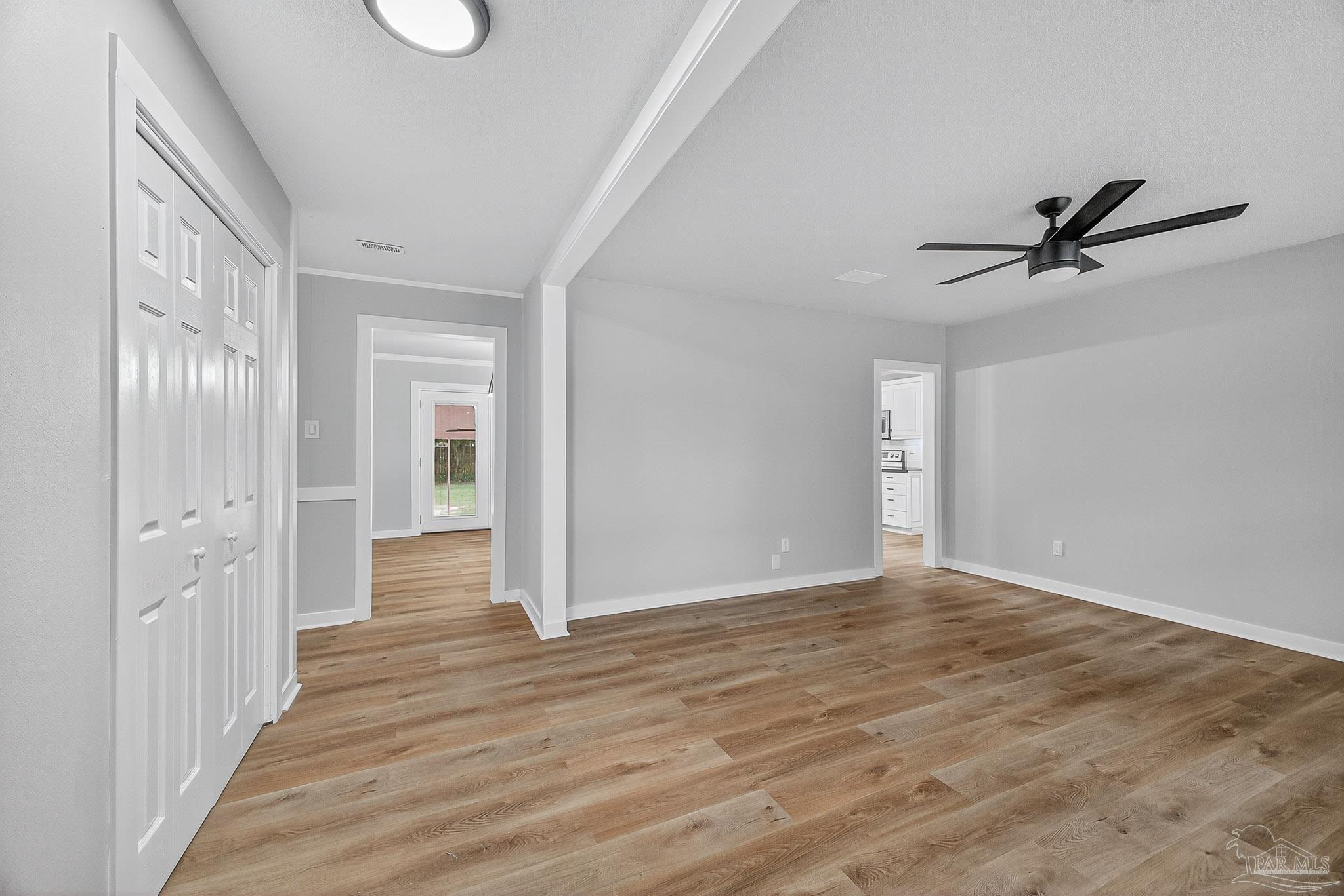 4673 Van Horn Road Milton, FL 32583 - Photo 5 of 53 a view of a hallway with wooden floor and a ceiling fan