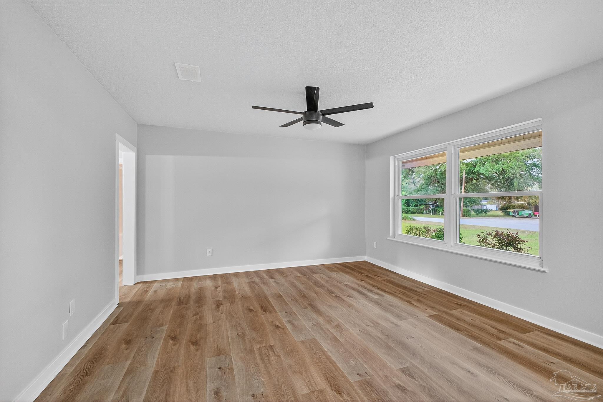 4673 Van Horn Road Milton, FL 32583 - Photo 7 of 53 a view of empty room with wooden floor and fan