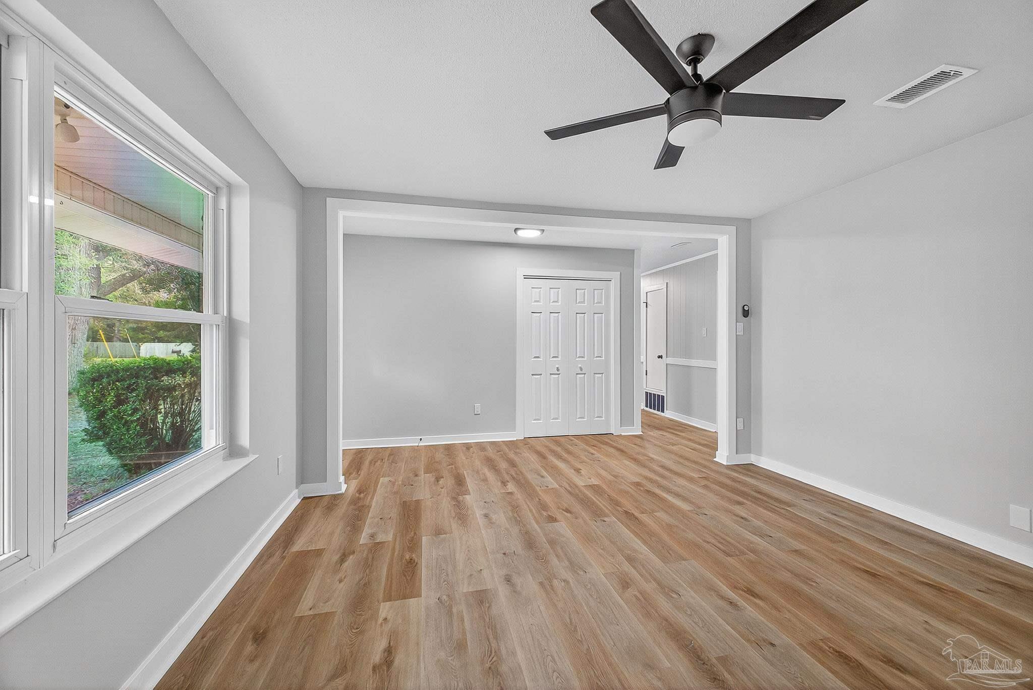 4673 Van Horn Road Milton, FL 32583 - Photo 9 of 53 a view of empty room with wooden floor and fan