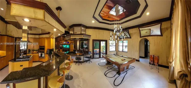 a living room with furniture a ceiling fan and a window