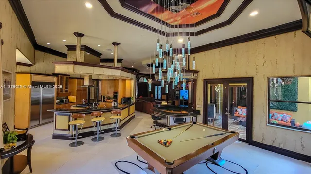 a view of a patio with table and chairs potted plants