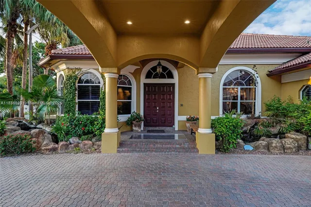 a view of a chairs and table in the patio with a barbeque
