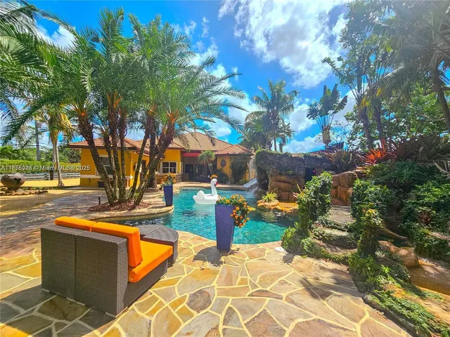 a bedroom with a bed dresser and a flat tv screen