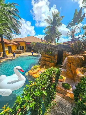 a bedroom with a bed next to a window