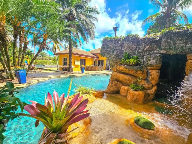 a view of a swimming pool with an outdoor space and seating area