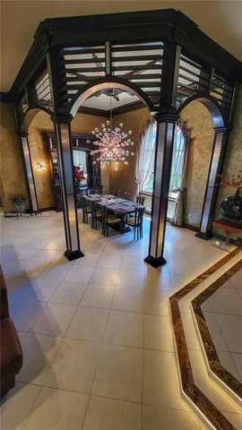 a view of a dining room with furniture and chandelier