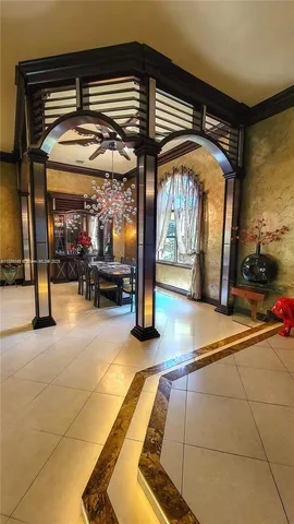 a view of a dining room with furniture wooden floor and chandelier