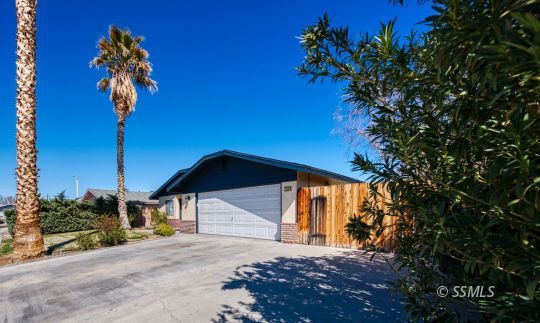 318 Reese Street Ridgecrest, CA 93555 - Photo 24 of 34 a view of a house with a tree and a yard