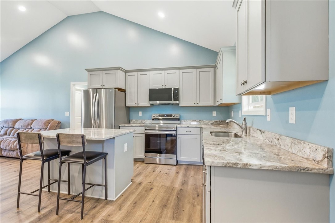 745 Dave Nix Road Seneca, SC 29678 - Photo 7 of 23 Culinary aspirations come alive in this kitchen, boasting ample counter space and modern appliances under a soaring vaulted ceiling.