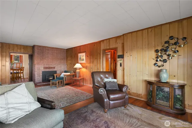a living room with furniture a window and a potted plant