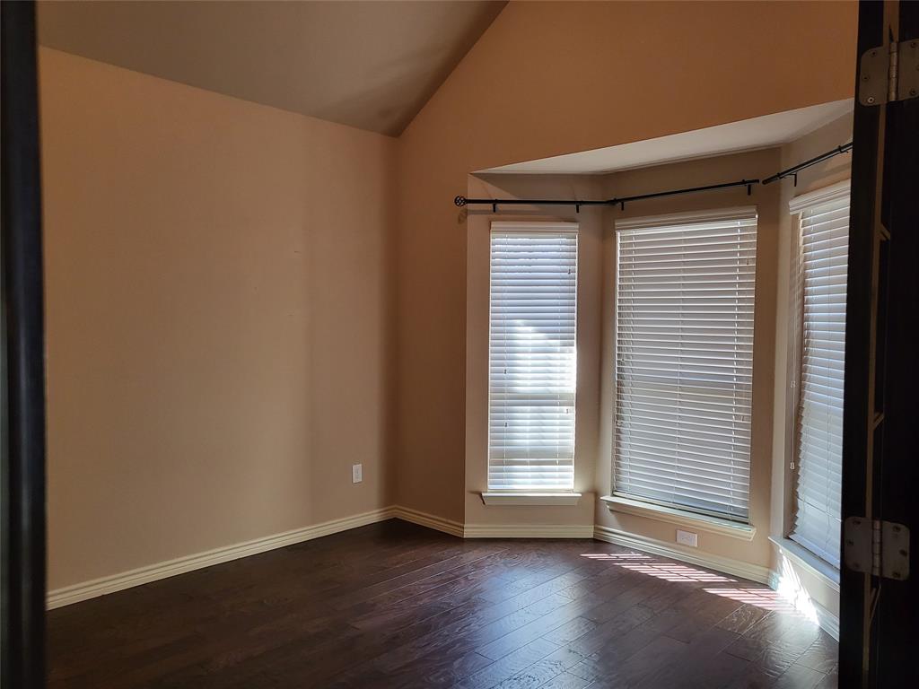 333 Cave River Drive Murphy, TX 75094 - Photo 13 of 26 an empty room with wooden floor and windows