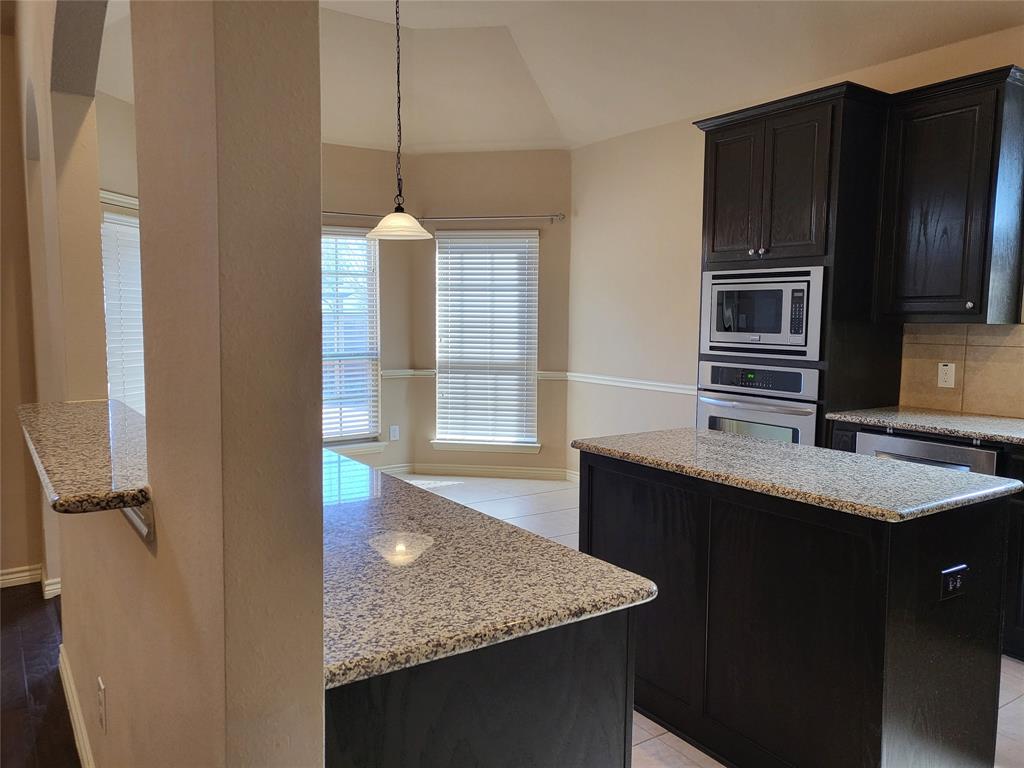333 Cave River Drive Murphy, TX 75094 - Photo 3 of 26 a kitchen with stainless steel appliances granite countertop a sink refrigerator and microwave