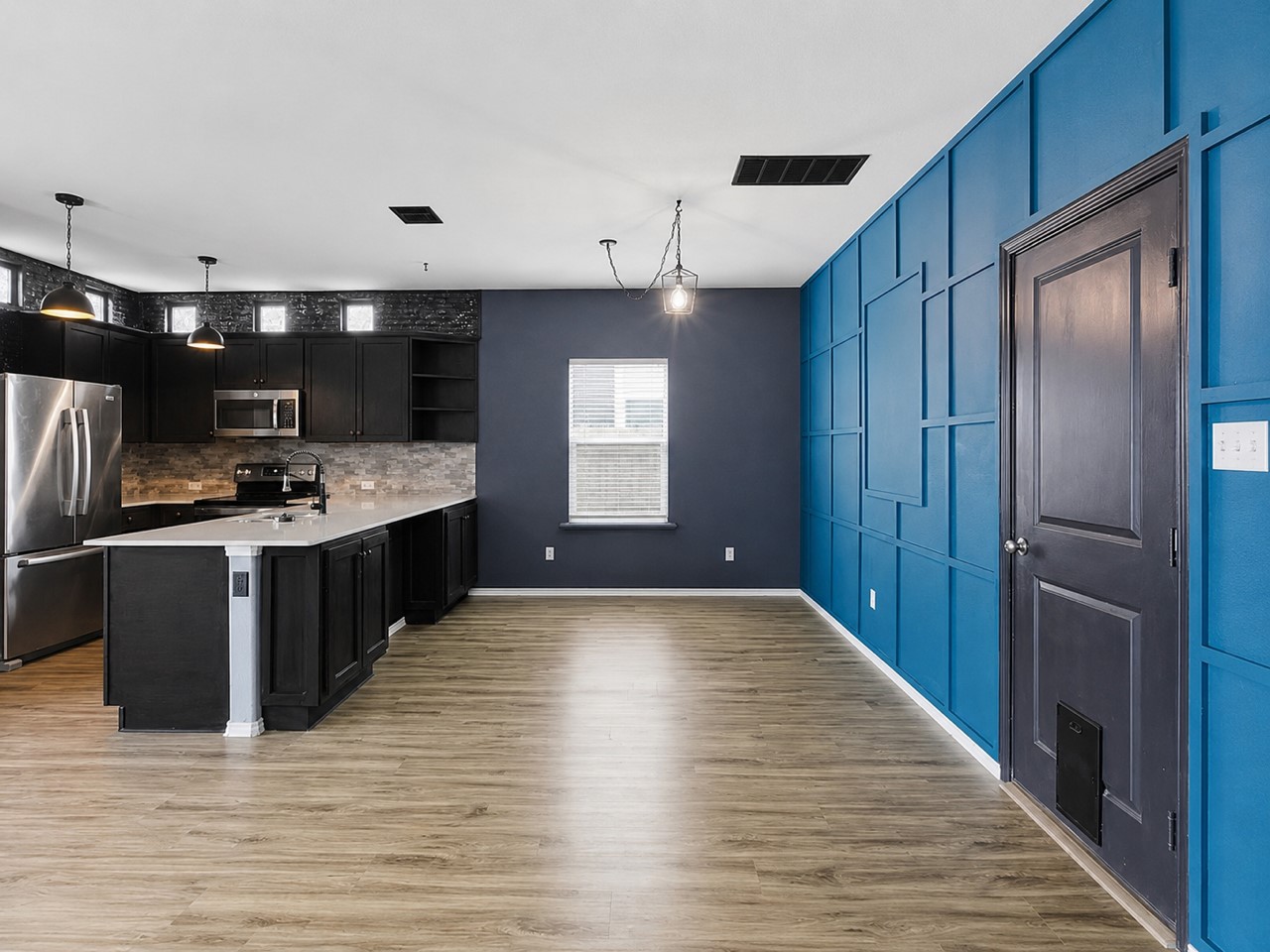 116 Night Riders Way Jarrell, TX 76537 - Photo 13 of 38 A contemporary kitchen and dining space combine sleek cabinetry with an accent wall.