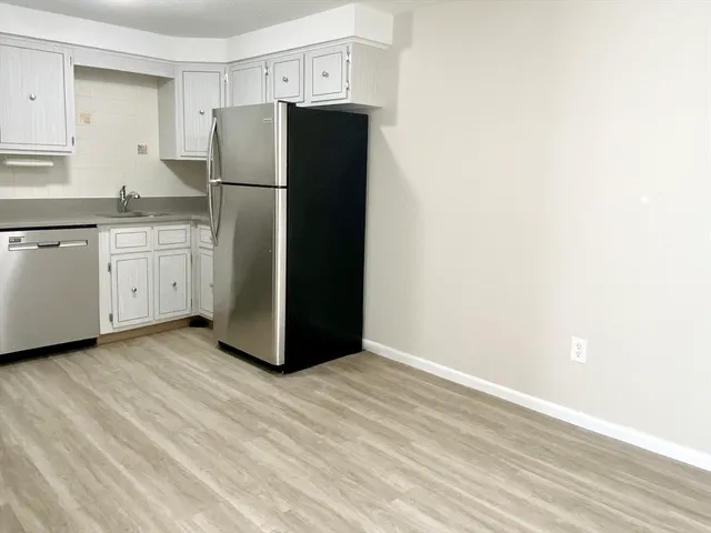 a kitchen with a refrigerator and a sink