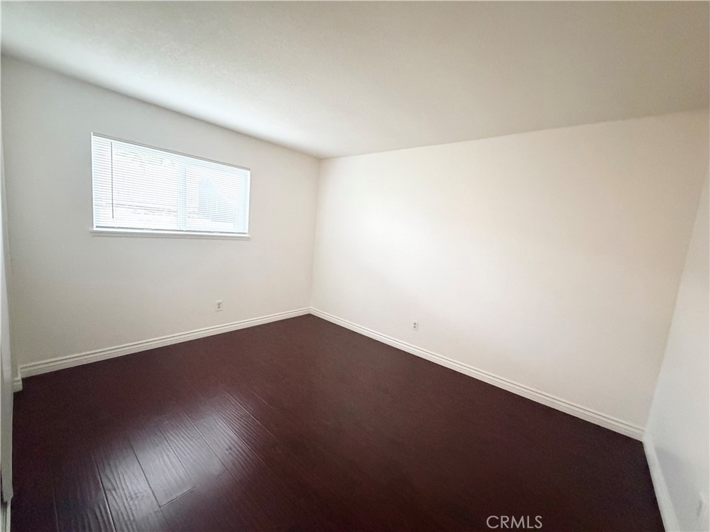 9668 Hemlock Street Rancho Cucamonga, CA 91730 - Photo 14 of 23 an empty room with wooden floor and windows
