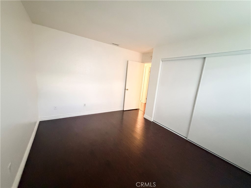 9668 Hemlock Street Rancho Cucamonga, CA 91730 - Photo 15 of 23 an empty room with wooden floor and white wall