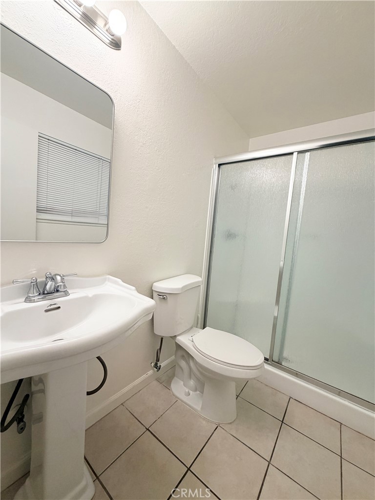 9668 Hemlock Street Rancho Cucamonga, CA 91730 - Photo 16 of 23 a bathroom with a sink a toilet a mirror and shower