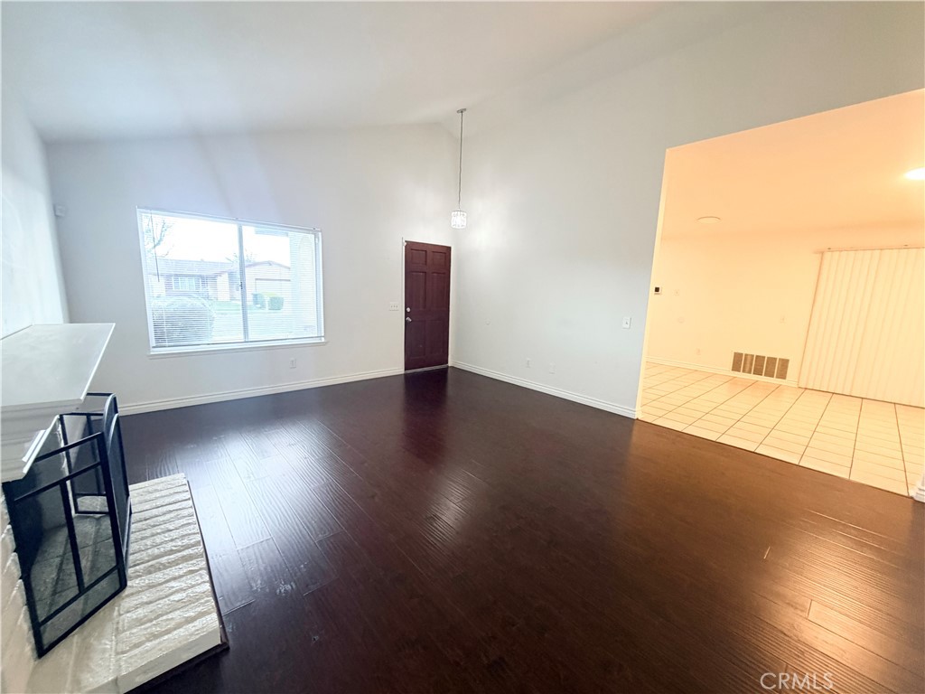 9668 Hemlock Street Rancho Cucamonga, CA 91730 - Photo 3 of 23 an empty room with wooden floor and windows