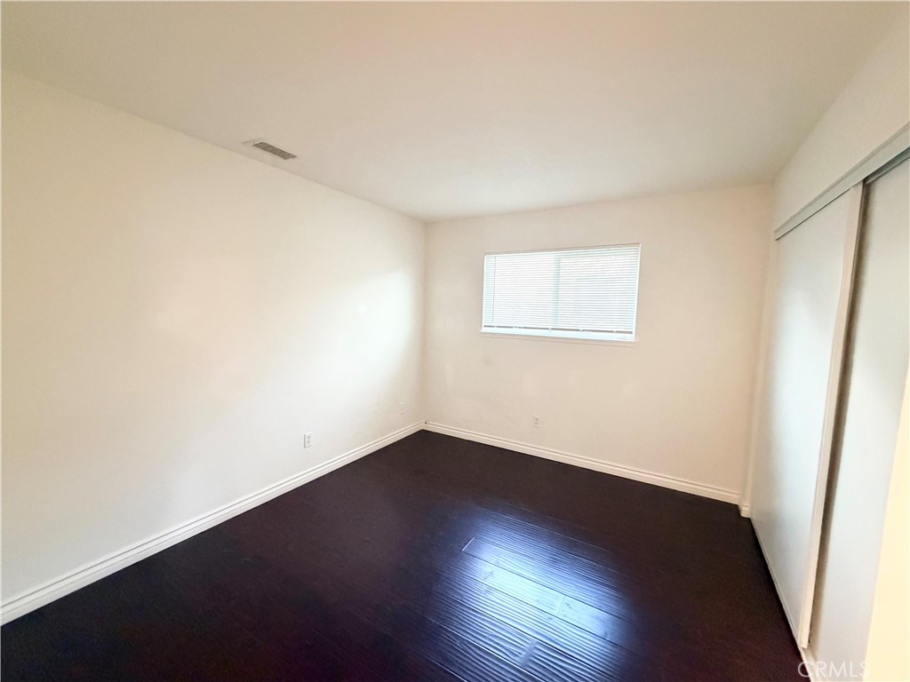 9668 Hemlock Street Rancho Cucamonga, CA 91730 - Photo 10 of 23 an empty room with wooden floor and windows
