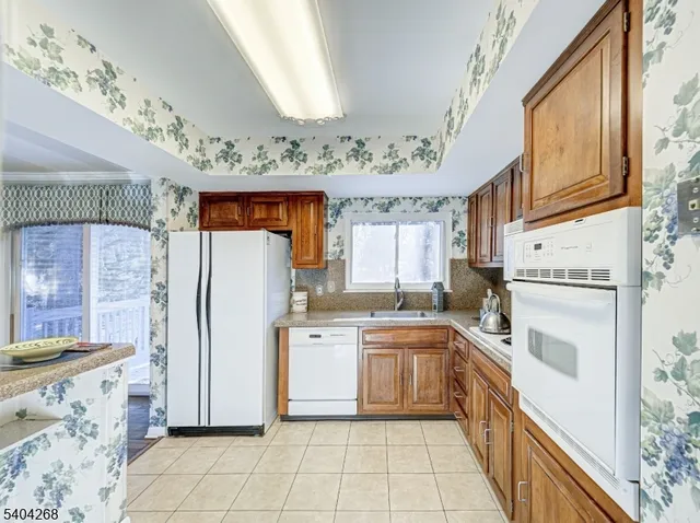 a kitchen with a sink a refrigerator and cabinets