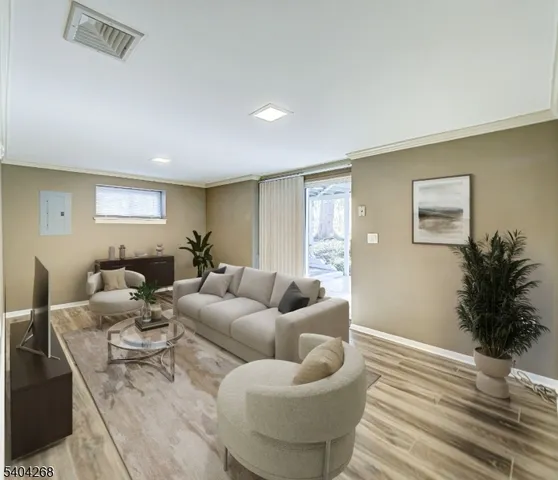 a living room with furniture and a potted plant