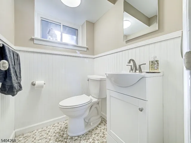 a bathroom with a sink toilet and a mirror