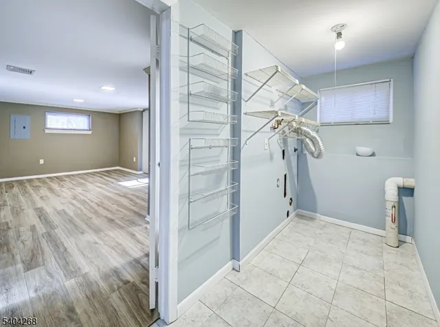 a view of a livingroom with wooden floor and window